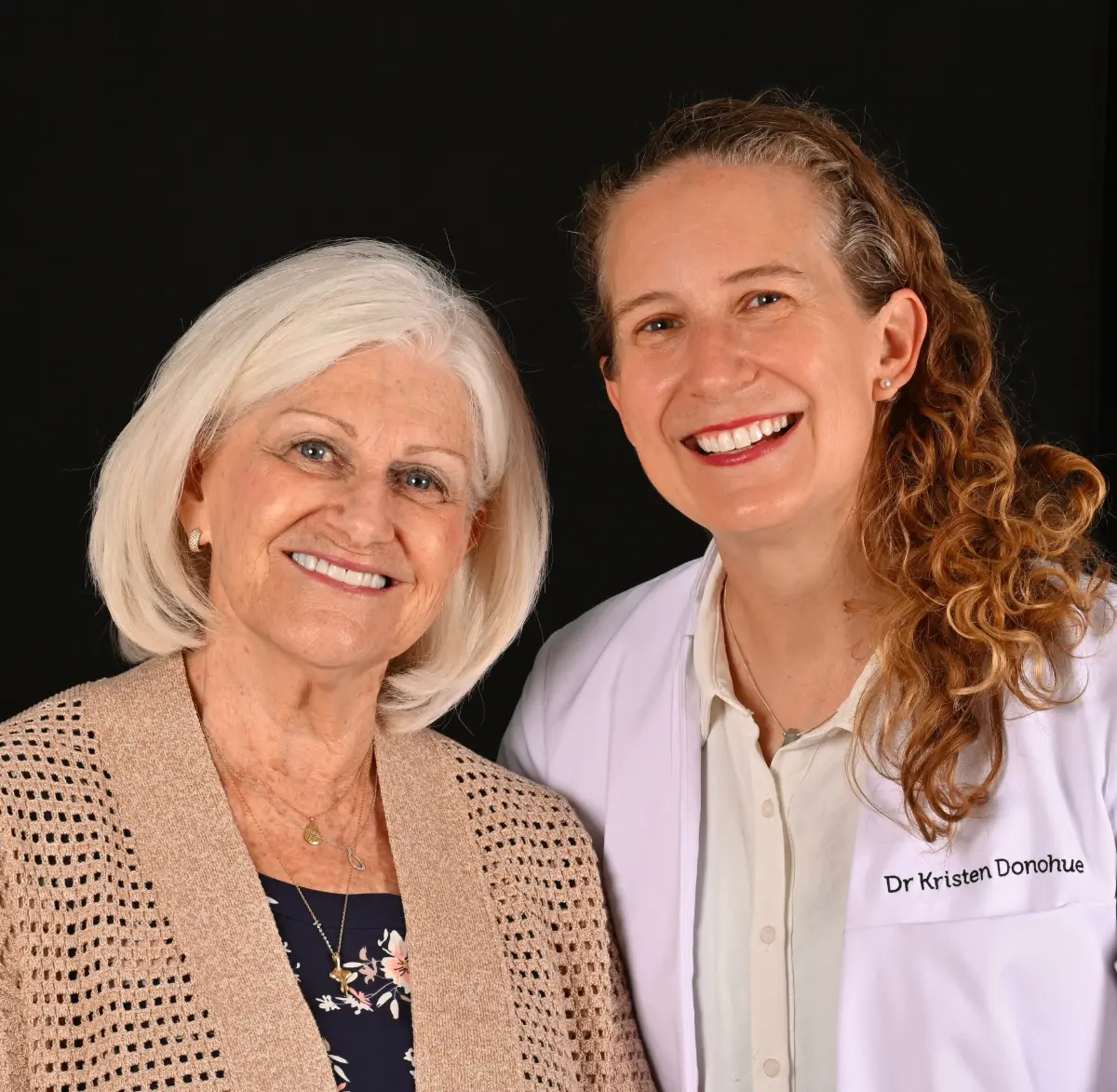 Dr. Kristen Donohue and a senior patient smiling together at Sunshine Dentists