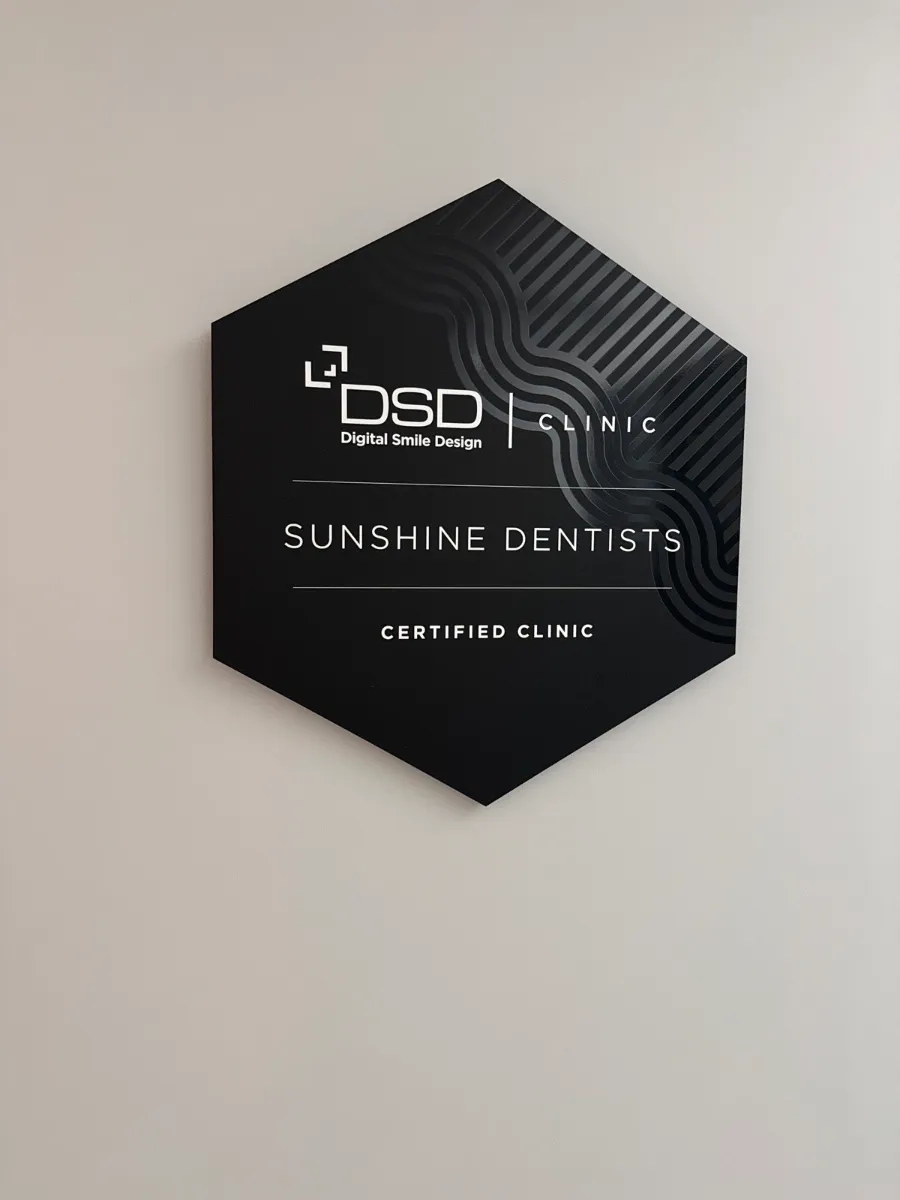 Sunshine Dentists Digital Smile Design (DSD) certified clinic sign on the office wall